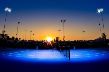 Blue tennis court at twilight
